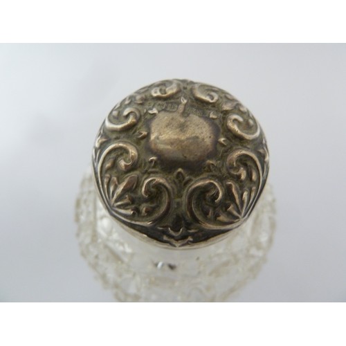 44 - A silver mounted cut glass perfume bottle, screw top, globular and cut with a hobnail pattern, Birmi... 