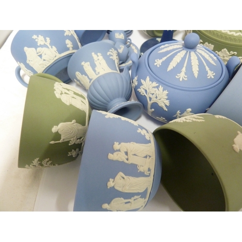 119 - A group of Wedgwood Jasper wares, comprising: a circular sugar box and cover, eight teacups, an urn ... 