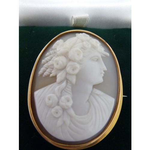 39 - A cameo brooch, of a young woman with rose garlanded hair, set in unmarked yellow metal, 13.2 grms t... 