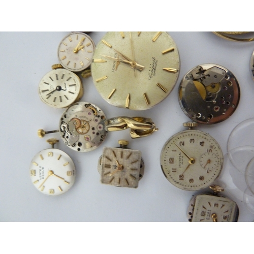 24 - A restorers box of watch parts, invcludinga movements/dials marked Garrard, Longines, Tissot etc; an... 