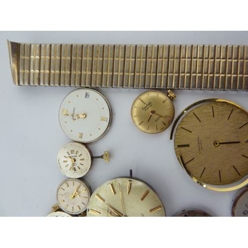 24 - A restorers box of watch parts, invcludinga movements/dials marked Garrard, Longines, Tissot etc; an... 