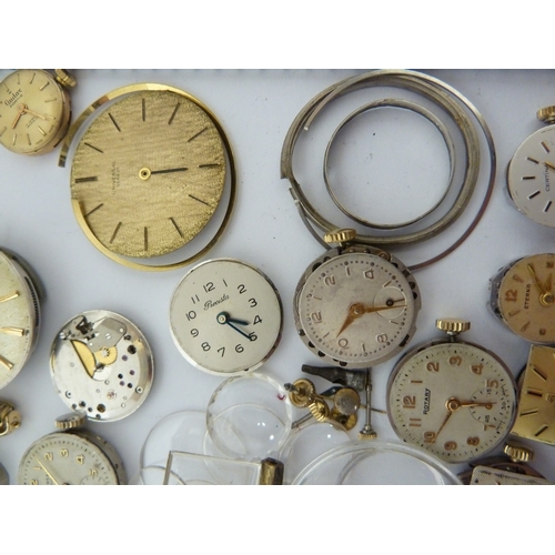 24 - A restorers box of watch parts, invcludinga movements/dials marked Garrard, Longines, Tissot etc; an... 