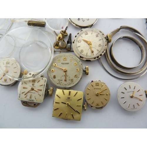 24 - A restorers box of watch parts, invcludinga movements/dials marked Garrard, Longines, Tissot etc; an... 