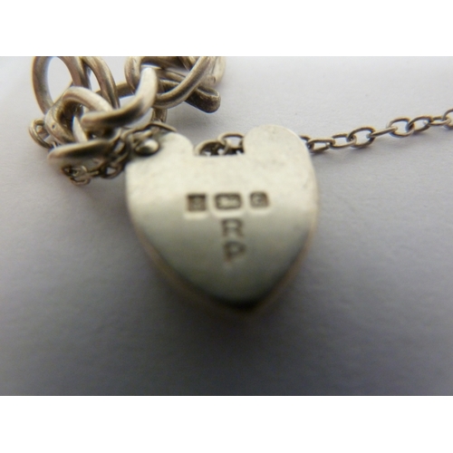 18 - A silver bracelet with heart form padlock clasp; a stick pin modelled as a horse head and riding cro... 