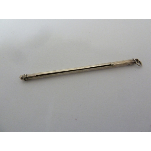 29 - A white metal cocktail swizzle stick, marked indistinctly, closed 8.5 cm max.