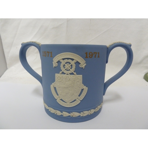 136 - A group of Wedgwood jasper wares, comprising: a two handled loving cup, a jug, a candlestick, a part... 