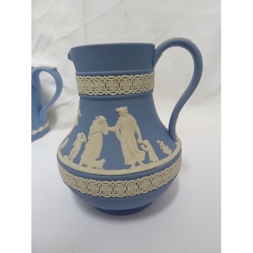 136 - A group of Wedgwood jasper wares, comprising: a two handled loving cup, a jug, a candlestick, a part... 