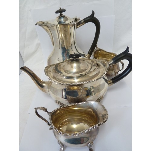 21 - A William Hutton & Sons four piece silver tea set, comprising teapot, milk jug and two handled sugar... 