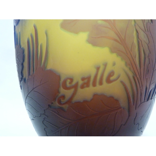 34 - Galle - a cameo glass vase decorated with blue flowers on a yellow ground, 15cm high.