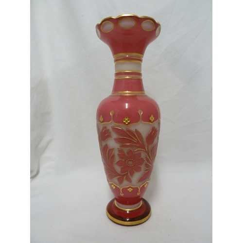 93 - A Bohemian glass vase, of bright pink cut through to opaque white with a band of scrolling flowers a... 