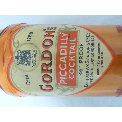 189 - A Gordon's Piccadilly Cocktail shaker, of orange glass, original paper labels and cover, 24cm high