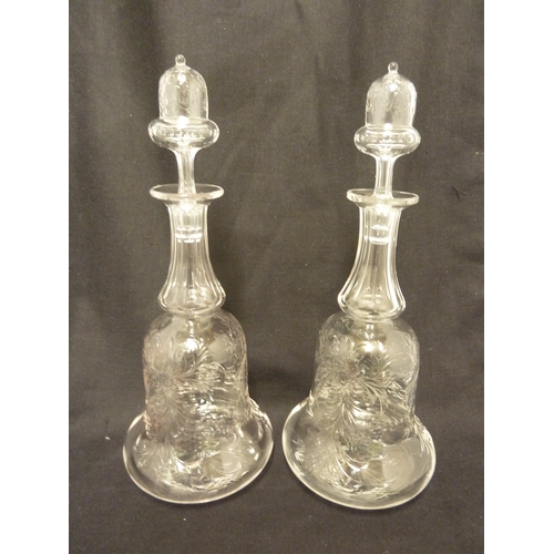 176 - Stevens and Williams - a pair of intaglio cut glass decanters, bell form with acorn form stoppers cu... 