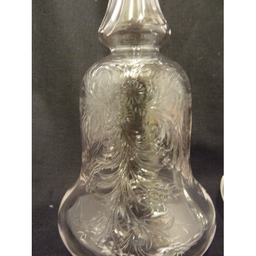 176 - Stevens and Williams - a pair of intaglio cut glass decanters, bell form with acorn form stoppers cu... 