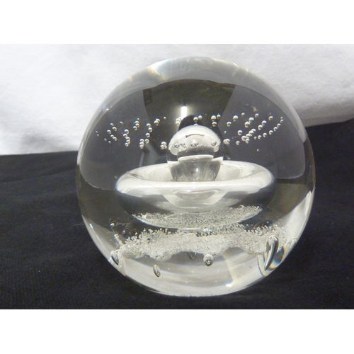 32 - A Caithness glass paperweight - Starwatch, with air inclusion of a globular 'planet' with concentric... 