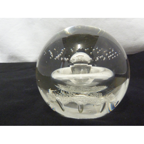 32 - A Caithness glass paperweight - Starwatch, with air inclusion of a globular 'planet' with concentric... 