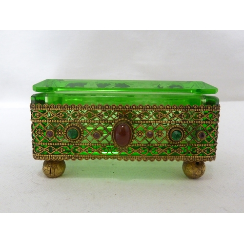 92 - Heinrich Hoffman - A green glass box and cover, decorated with and set in a gilded metal frame appli... 