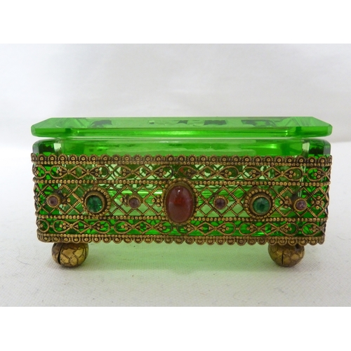 92 - Heinrich Hoffman - A green glass box and cover, decorated with and set in a gilded metal frame appli... 