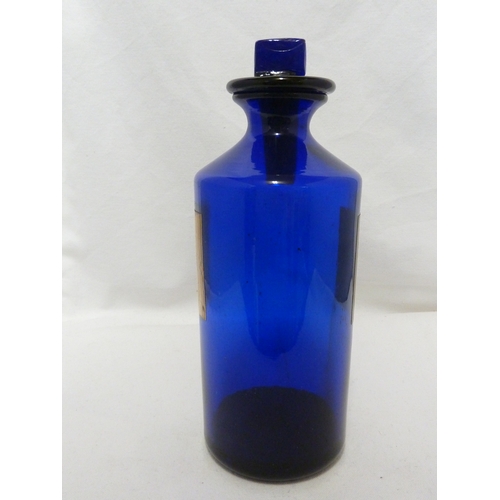 169 - A blue glass pharmacy bottle labelled SYR.SCILL. B.P.C, 25cm high