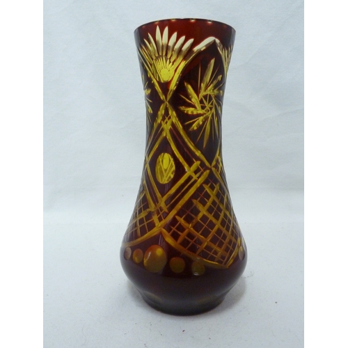 97 - A Bohemian overlay glass vase, of ruby cut through to pale green with trellis, lenses and spiral sun... 