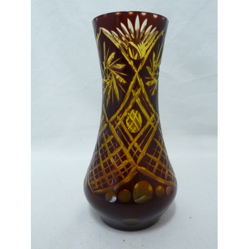 97 - A Bohemian overlay glass vase, of ruby cut through to pale green with trellis, lenses and spiral sun... 