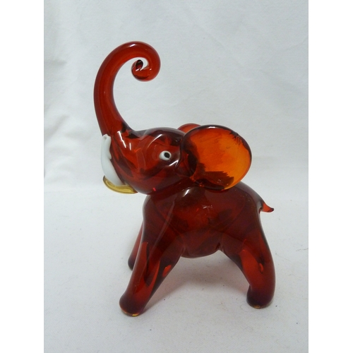 141 - Murano Glass - Two Elephant figures, of ruby and white, with opaque white glass tusks, 24cm high (2)