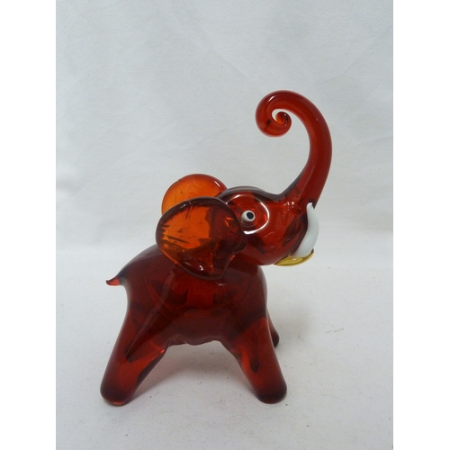 141 - Murano Glass - Two Elephant figures, of ruby and white, with opaque white glass tusks, 24cm high (2)