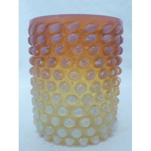 116 - An opaline glass beaker, the whole moulded with nail head design, graduating pink colour, perhaps A.... 