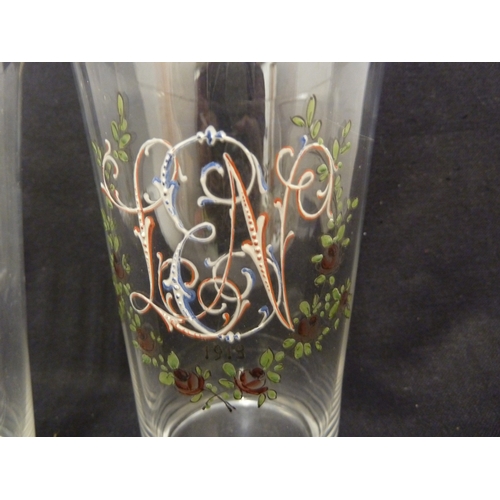 82 - A pair of French glass beakers, probably Baccarat, enamelled with initials and red rose swags, each ... 