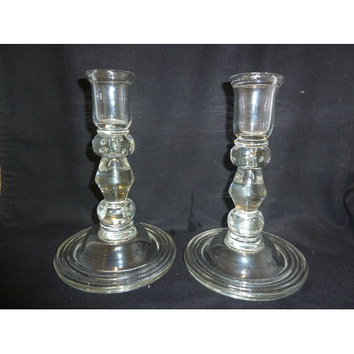 213 - A pair of English 18th Century glass candlesticks, of large size, the bobbin stems with bubble inclu... 