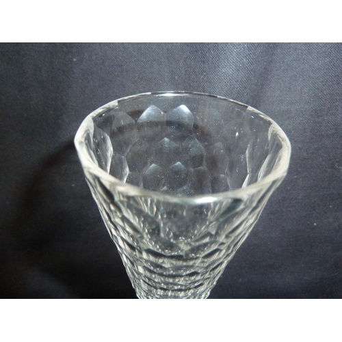 205 - A honeycomb cut glass wine, the slender trumpet bowl on faceted stem and solid domed facetted foot w... 