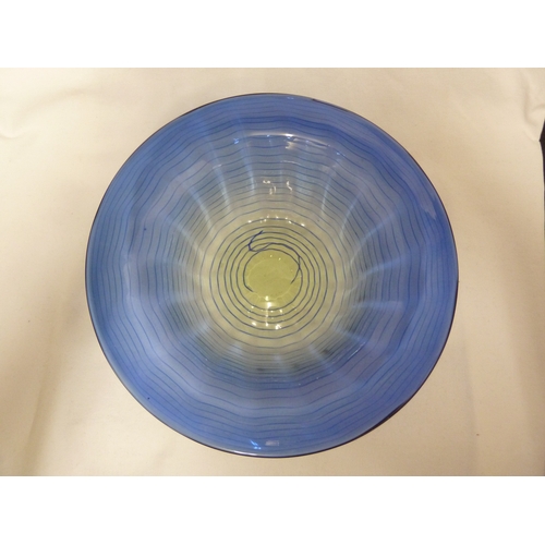 10 - James Powell and Son, Whitefriars Limited - A blue thread on sea green ground glass bowl, 26cm diam.