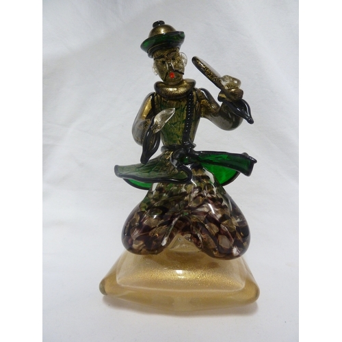 135 - Barovier & Toso - A glass figure of a Chinaman, seated on a large cushion shaped base and holding a ... 