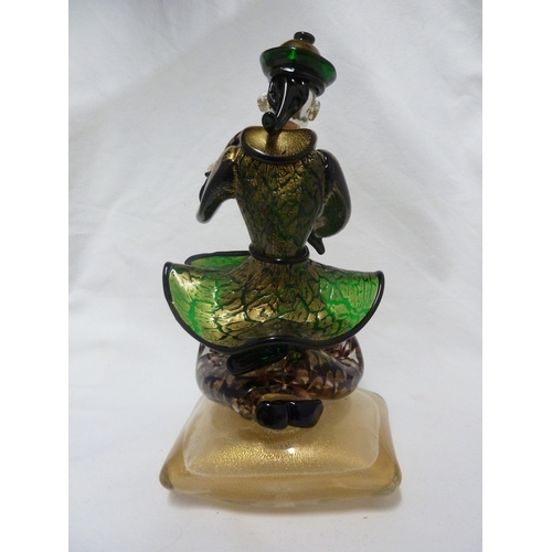 135 - Barovier & Toso - A glass figure of a Chinaman, seated on a large cushion shaped base and holding a ... 