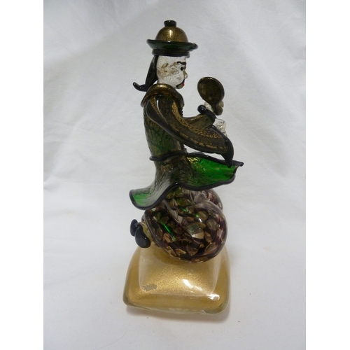 135 - Barovier & Toso - A glass figure of a Chinaman, seated on a large cushion shaped base and holding a ... 