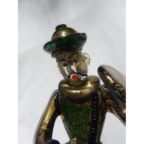 135 - Barovier & Toso - A glass figure of a Chinaman, seated on a large cushion shaped base and holding a ... 