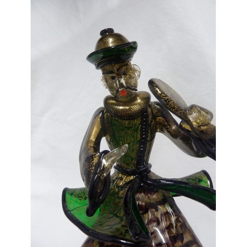 135 - Barovier & Toso - A glass figure of a Chinaman, seated on a large cushion shaped base and holding a ... 