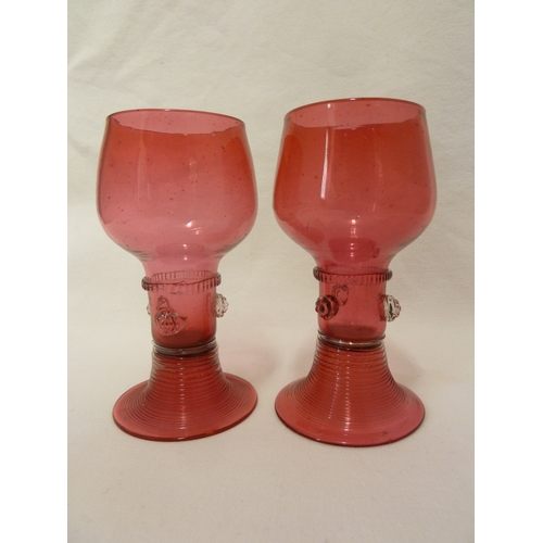 5 - James Powell and Sons, Whitefriars Limited - A pair of cranberry glass hock glasses with applied pru... 