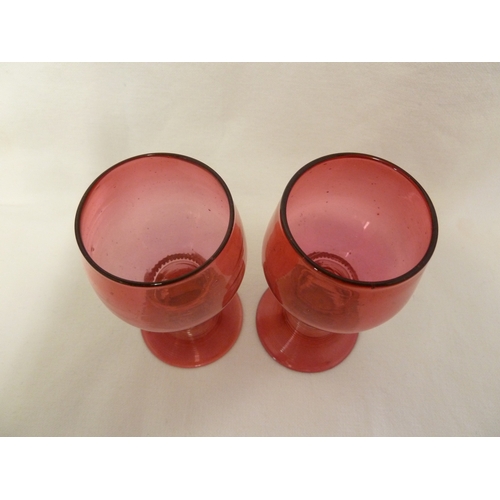 5 - James Powell and Sons, Whitefriars Limited - A pair of cranberry glass hock glasses with applied pru... 