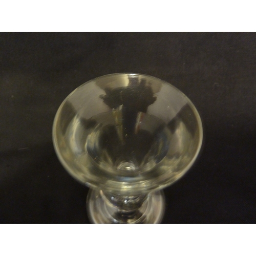 212 - A Deceptive dram glass, the thick conical bowl raided on an inverted baluster stem and domed foot, 1... 