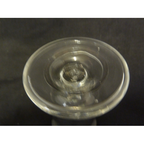 212 - A Deceptive dram glass, the thick conical bowl raided on an inverted baluster stem and domed foot, 1... 