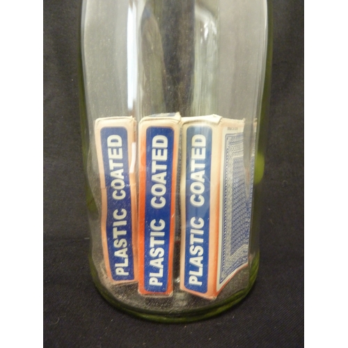 194 - A glass puzzle bottle, containing packs of cards in boxes, 20th Century, 34cm high approx.