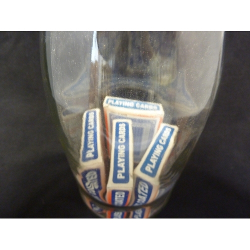 194 - A glass puzzle bottle, containing packs of cards in boxes, 20th Century, 34cm high approx.