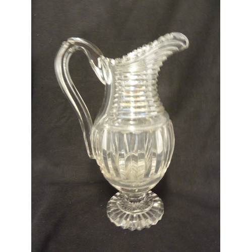 199 - A Georgian step glass cut water jug, of fluted body and applied strap handle, 21cm high