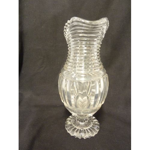 199 - A Georgian step glass cut water jug, of fluted body and applied strap handle, 21cm high