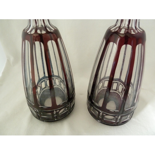 98 - Bohemian glass, a large pair of mallet form decanters of deep ruby overlay cut through to colourless... 