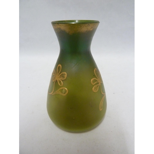 107 - Loetz - An iridescent green glass vase of flask form, tube lined and gilded with a flowering vine, 1... 