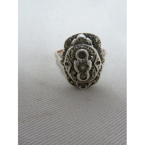 16 - A marcasite set dress ring, the shank stamped 9ct and SIL, ring size M, 5.4 grms; a Silver ring set ... 