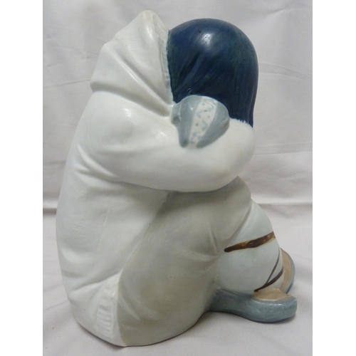 58 - A large size Lladro porcelain figure of a seated Inuit boy, polychrome colouring, impressed 2007, pr... 