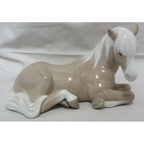 66 - A Lladro porcelain figure of Little Horse Resting, 1203; a Lladro figure of a Nativity donkey, 5483;... 