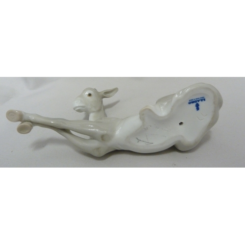 66 - A Lladro porcelain figure of Little Horse Resting, 1203; a Lladro figure of a Nativity donkey, 5483;... 